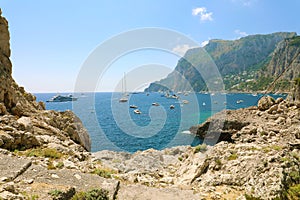 Coast of Capri Island with yachts in a beautiful summer day, Italy