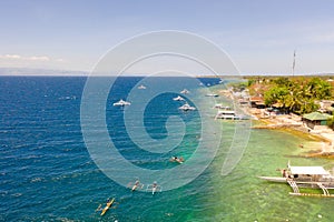 Coast of Cebu island, Moalboal, Philippines, top view. Boats near the shore in sunny weather