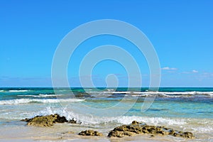 Coast of Corralejo. Emerald ocean and blue sky.