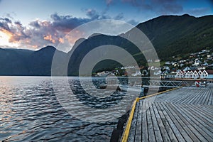 Coast of the fjord in Norway, Aurland fjord and city at sunset, beautiful Scandinavian landscape, travel to Norway