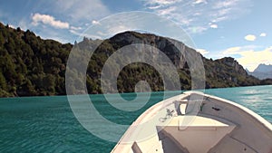 Coast of green mountain river view from boat in Patagonia Argentina.