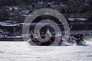 Coast Guard hovercraft breaking ice near a small community in eastern Quebec, Canada. photo