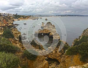 The coast of Lagos in Portugal, the Algarve, on a cloudy day with blue and gray clouds, with rocks
