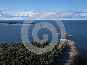 Coast and lighthouse Lange Erik in the north of the island of Öland in the east of Sweden from above in the sun