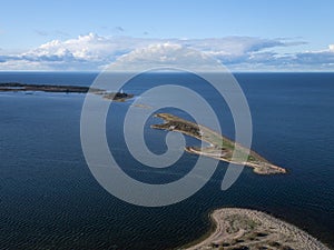 Coast and lighthouse Lange Erik in the north of the island of Öland in the east of Sweden from above in the sun