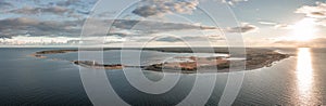 Coast and lighthouse Lange Erik in the north of the island of Öland in the east of Sweden from above during sunset