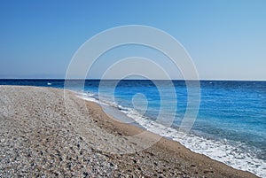 Coast of Mediterranean Sea. pebble beach at the Sunny Day