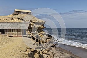 Coast of the Namibe Desert with canyons and wooden houses Angola. Africa