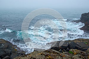 Coast nearby Stretisviti lighthouse on a misty summer evening, Iceland