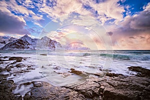 Coast of Norwegian sea on rocky coast in fjord on sunset