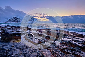 Coast of Norwegian sea on rocky coast in fjord on sunset