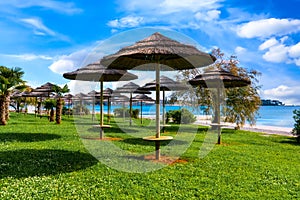 Coast of Porec with parasols on the beach promenade