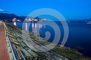 Coast of the port of Ushuaia at sunset with large ships with their lights on