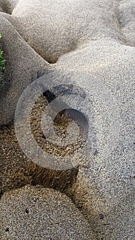 A lying naked human body, Parangtritis beach rock formation by erosion