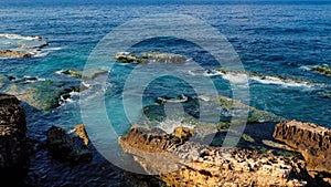 Coast with rocks at the sea, clear blue and emerald colored water