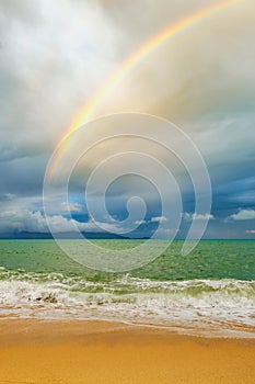 Coast of the sea with rainbow at tropical beach