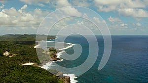 The coast of Siargao island, blue ocean and waves.