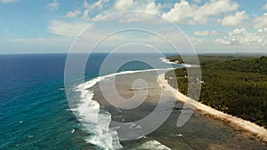 The coast of Siargao island, blue ocean and waves.