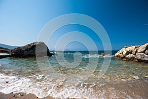 Coast with stones. Water interruptions through the stones