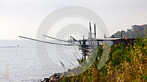 Coast of the Trabocchi, Trabocco in Marina di San Vito Chietino, Abruzzo-Italy. The Trabocco is a traditional wooden fishing house photo