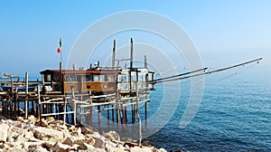 Coast of the Trabocchi, Trabocco in Marina di San Vito Chietino, Abruzzo-Italy. The Trabocco is a traditional wooden fishing house photo