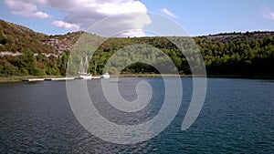 Coast view from a boat with sun splitting the sea in half