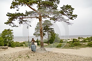 On the coast of the White Sea, a girl swinging on a swing.