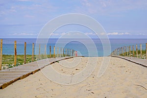 Coast wooden access sandy pathway fence to ocean beach atlantic coast at Cap-Ferret in France