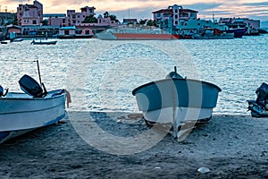 Coastal beach with front view of motorboat on sand