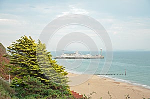 Coastal beach scenery and Bournemouth pier along Bournemouth beach in Dorset.