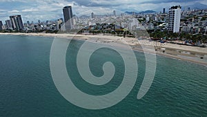 Coastal city skyline with skyscrapers seen from beach 5K view Da Nang Vietnam Asia