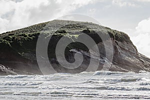 Coastal cliff fronts where the land meets the sea. Wharariki Beach