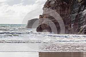 Coastal cliff fronts where the land meets the sea. Wharariki Beach