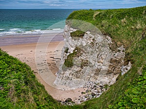 Coastal cliffs showing exposed strata near Portrush on the Antrim Causeway Coast Path - these rocks are of the Hibernian
