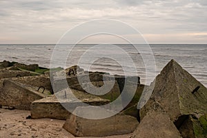 Coastal Constructs: Stacked Concrete Blocks Along the Seashore, Echoes of Man and Nature's Collide