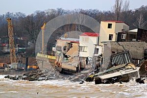 Coastal erosion - houses built on weak clay soil slide down to the sea