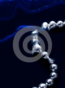 Coastal jewellery fashion, pearl necklace under blue water background, glamour style present and chic gift for luxury jewelery