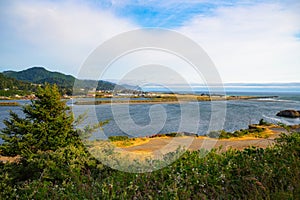 Coastal landscape of Gold Beach, Oregon, with Rogue River and mountains