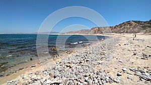 Coastal landscape of La Ventana Bay, stone lined hot springs on the beach, Playa Agua Caliente, BCS, Mexico photo