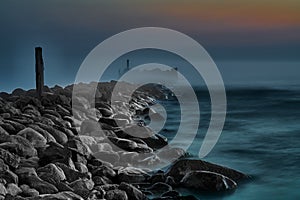 Coastal landscape with old broken pier, Baltic Sea, Latvia. Long exposure. Fog. twilight