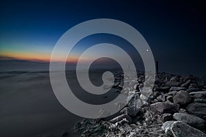 Coastal landscape with old broken pier, Baltic Sea, Latvia. Long exposure. Fog. twilight