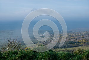 Coastal moorland with mist cloud with sea in the distance