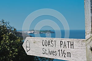 Coastal path sign to St Ives with St Ives in the distance