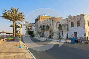 Coastal promenade in the ancient city of Quseir in Egypt. Landmark in photo is a historic building built of sea corals. Old Road.