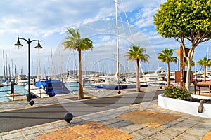 Coastal promenade in marina Rubicon with yacht boats