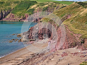 Coastal red cliffs near Manorbier in Pembrokeshire, Wales, UK