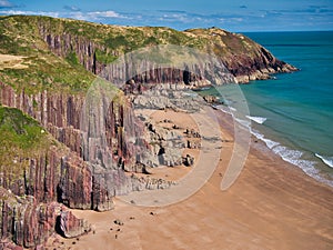 Coastal red cliffs near Manorbier in Pembrokeshire, Wales, UK