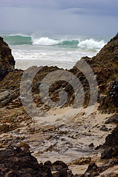 Coastal Rockformation with crashing waves background