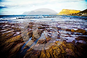 Coastal rocks glimmering in dawn light