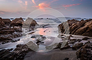 Coastal rocks and reflections in dawn hours